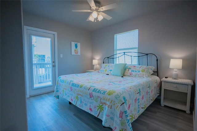 bedroom featuring access to exterior, dark hardwood / wood-style floors, and ceiling fan