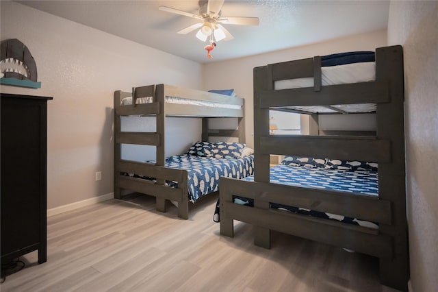 bedroom with ceiling fan and light hardwood / wood-style floors