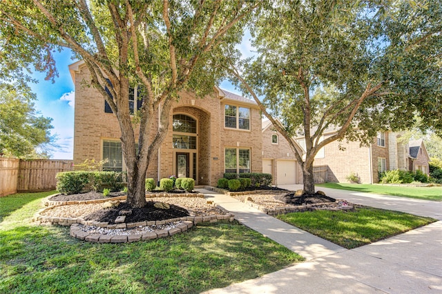 view of front of house featuring a garage and a front lawn