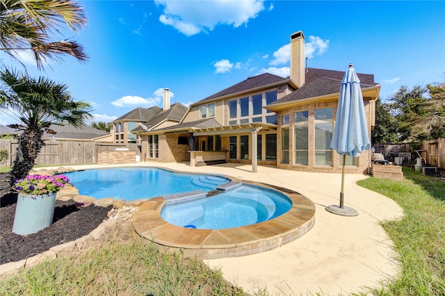 view of pool featuring an in ground hot tub, a pergola, and a patio