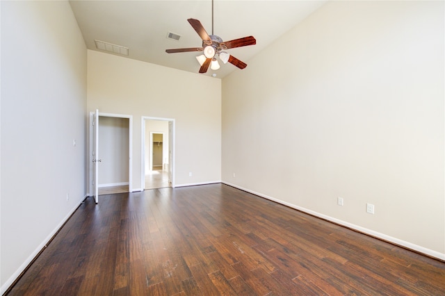 unfurnished bedroom with high vaulted ceiling, ceiling fan, and dark wood-type flooring