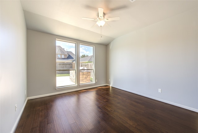 unfurnished room featuring ceiling fan, lofted ceiling, and dark wood-type flooring