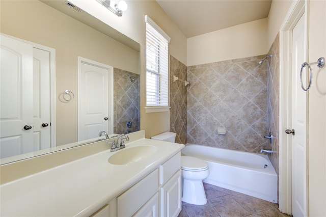 full bathroom with vanity, tiled shower / bath combo, toilet, and tile patterned flooring