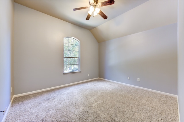 unfurnished room with ceiling fan, carpet floors, and vaulted ceiling