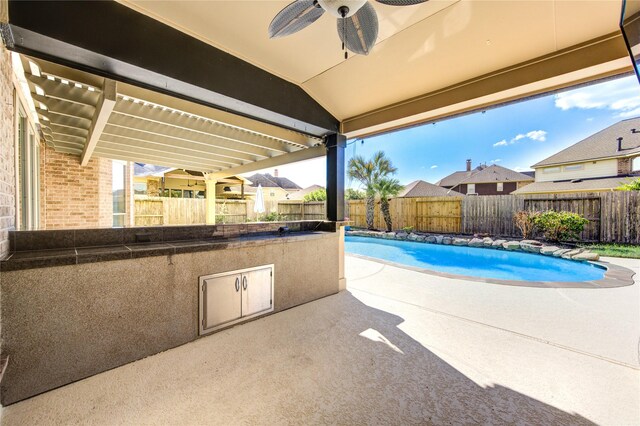 view of swimming pool featuring a pergola, ceiling fan, and a patio area