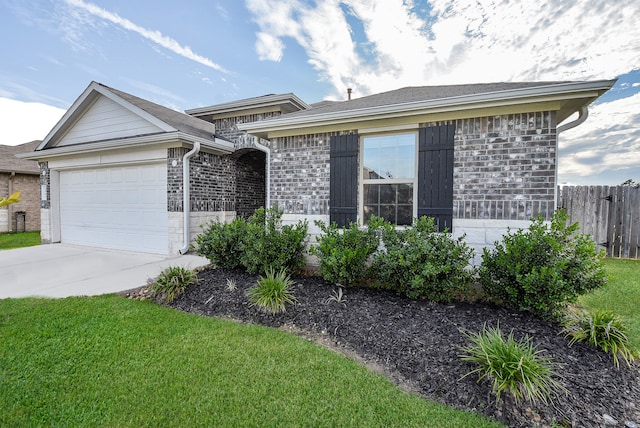 ranch-style house featuring a front yard and a garage