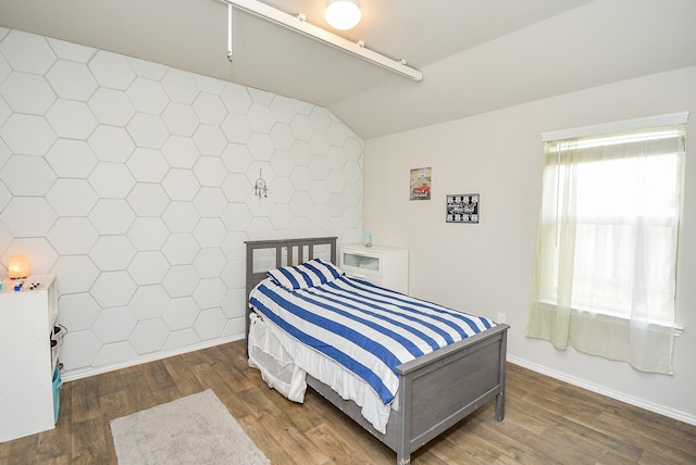 bedroom with lofted ceiling and dark hardwood / wood-style flooring