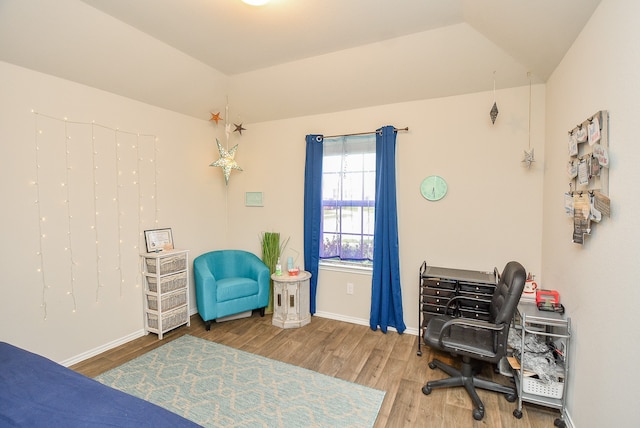 bedroom with wood-type flooring and lofted ceiling