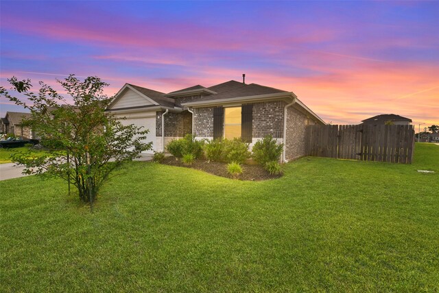 view of front facade featuring a lawn and a garage