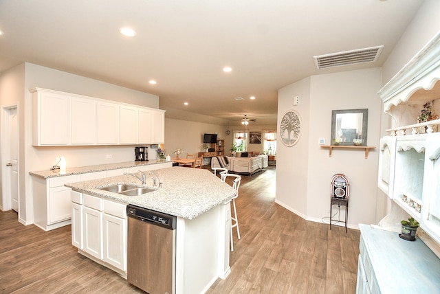 kitchen with white cabinets, dishwasher, light wood-type flooring, and sink