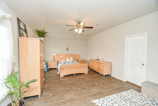 bedroom featuring ceiling fan, lofted ceiling, and wood-type flooring