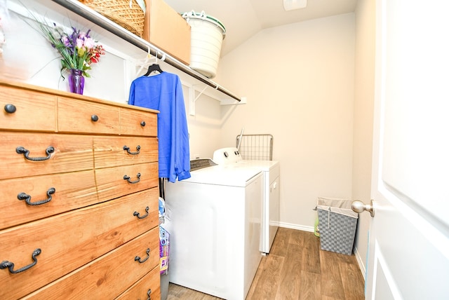 washroom with hardwood / wood-style floors and washer and dryer