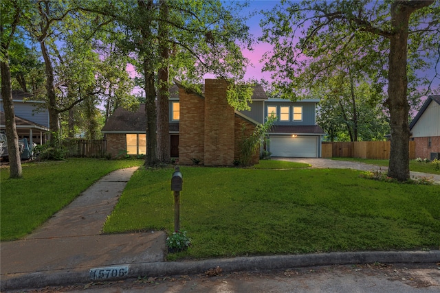 view of front of property featuring a lawn and a garage