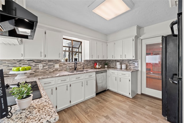 kitchen with light wood-type flooring, ventilation hood, sink, white cabinets, and stainless steel dishwasher