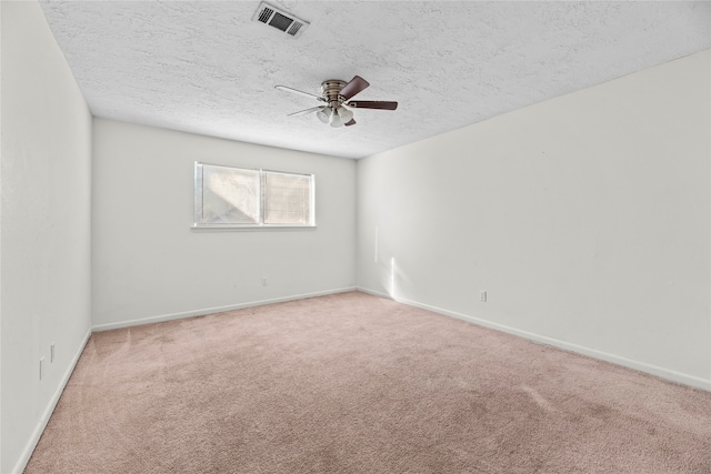 unfurnished room featuring ceiling fan, carpet flooring, and a textured ceiling