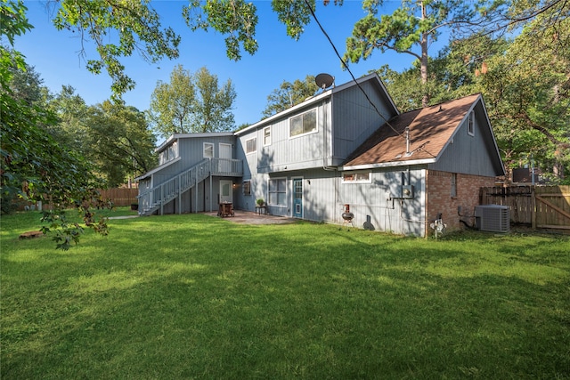 back of property featuring a lawn, a patio, and central AC unit