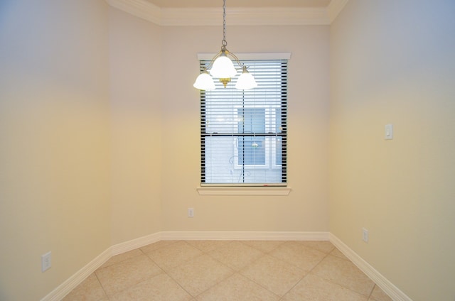 spare room with a chandelier and crown molding