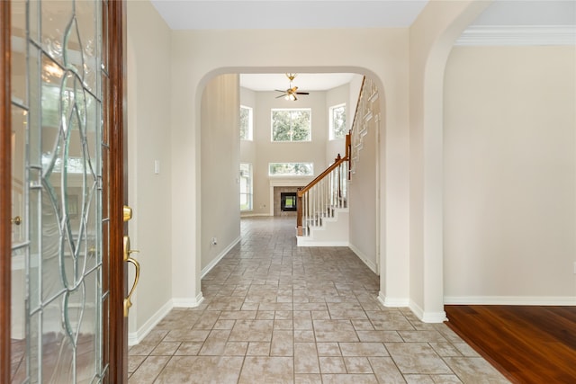 foyer entrance featuring light wood-type flooring and ornamental molding