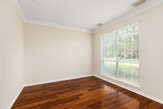 empty room with crown molding and dark hardwood / wood-style flooring