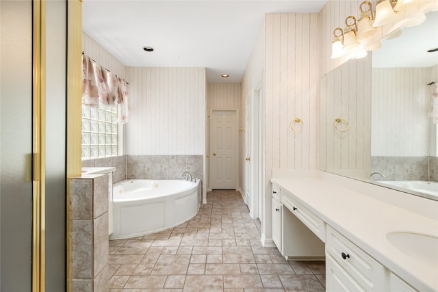 bathroom with vanity and a tub