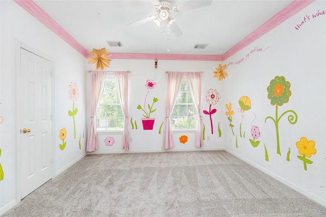 game room featuring ceiling fan, light carpet, and ornamental molding