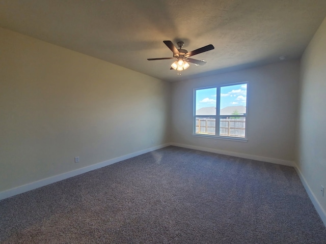 unfurnished room featuring carpet, ceiling fan, baseboards, and a textured ceiling