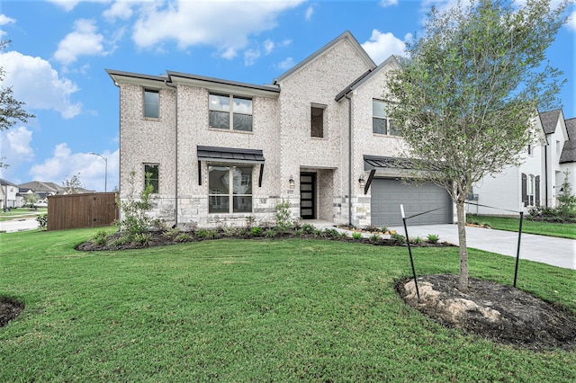 view of front of house featuring a garage and a front lawn