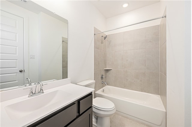 full bathroom with tiled shower / bath, vanity, and toilet