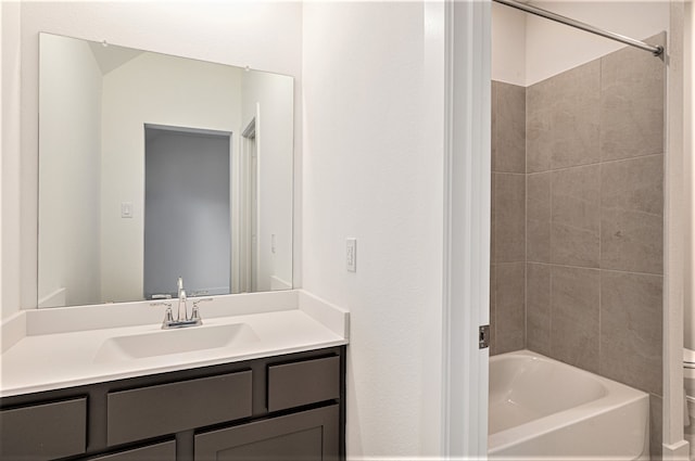 bathroom featuring tiled shower / bath combo and vanity