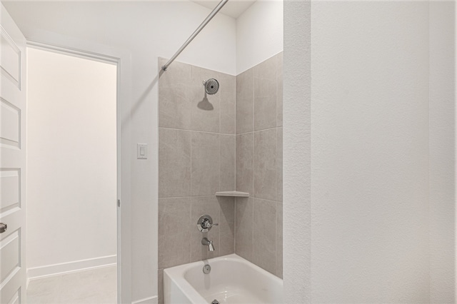 bathroom with tiled shower / bath combo and tile patterned floors