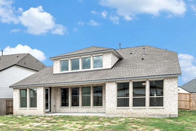 rear view of house with a yard