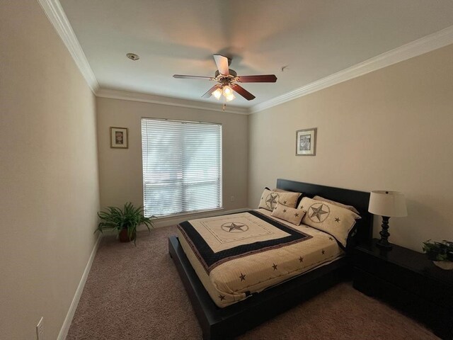 carpeted bedroom with ceiling fan and crown molding