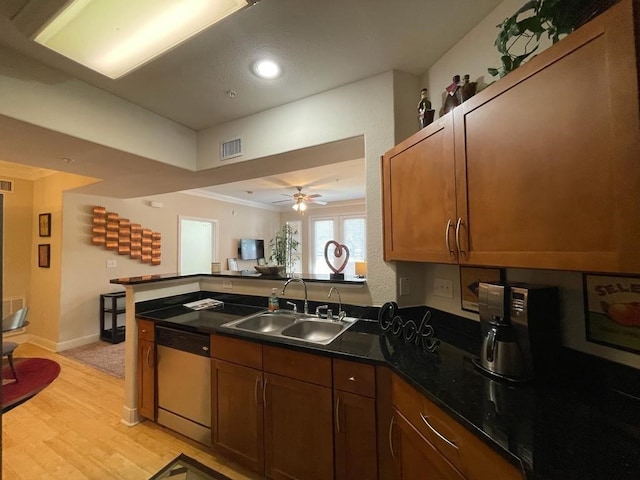 kitchen with light wood-type flooring, ceiling fan, stainless steel dishwasher, ornamental molding, and sink