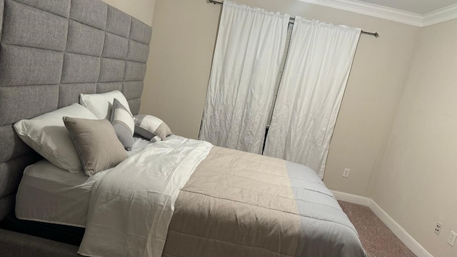 carpeted bedroom featuring crown molding