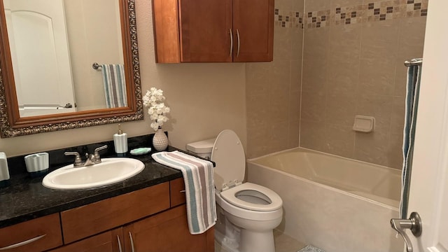 full bathroom with tiled shower / bath combo, vanity, and toilet