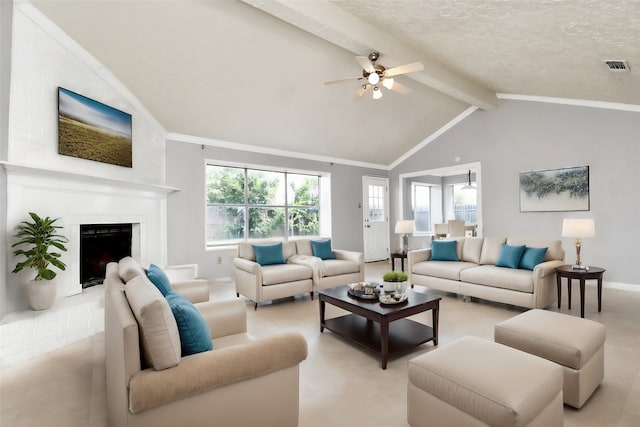 living room featuring vaulted ceiling with beams, ceiling fan, light tile patterned floors, a textured ceiling, and a fireplace