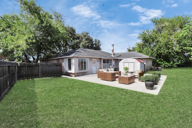 back of house featuring outdoor lounge area, a patio, and a lawn