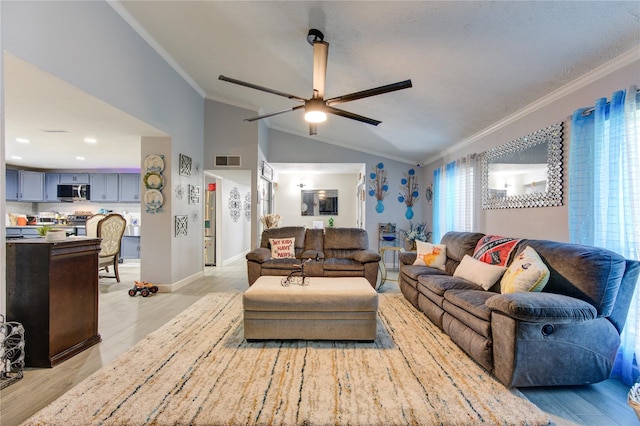 living room with light wood-type flooring, ornamental molding, vaulted ceiling, and a wealth of natural light