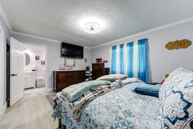 bedroom featuring a textured ceiling, light hardwood / wood-style flooring, connected bathroom, and crown molding