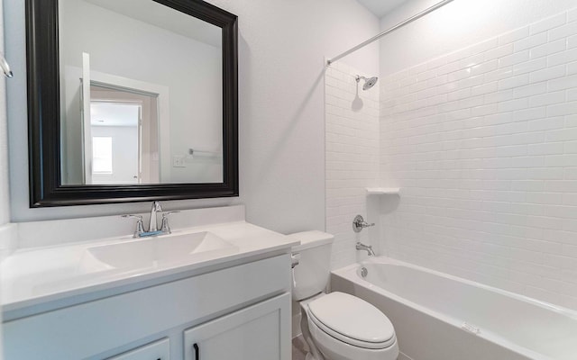 full bathroom with toilet, vanity, and tiled shower / bath