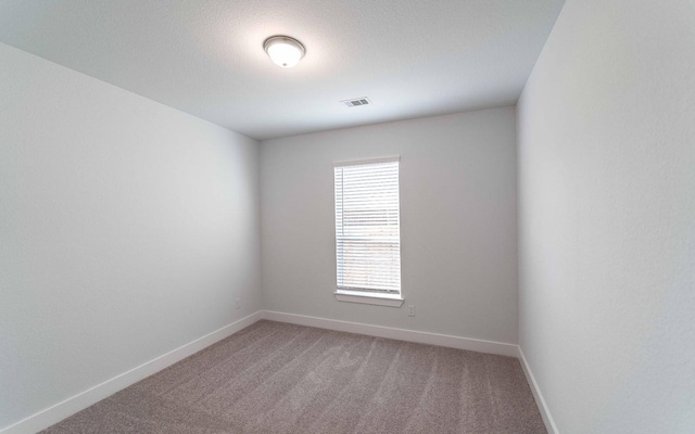 unfurnished room featuring carpet