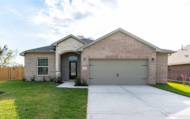 view of front of property featuring a garage and a front lawn