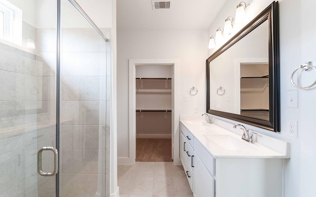 bathroom with vanity, tile patterned floors, and a shower with shower door