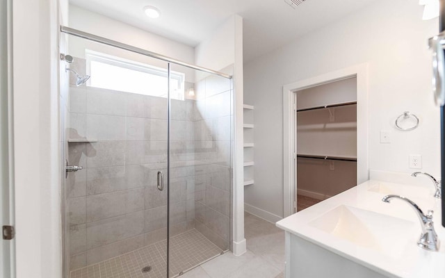 bathroom featuring vanity, tile patterned floors, and a shower with shower door