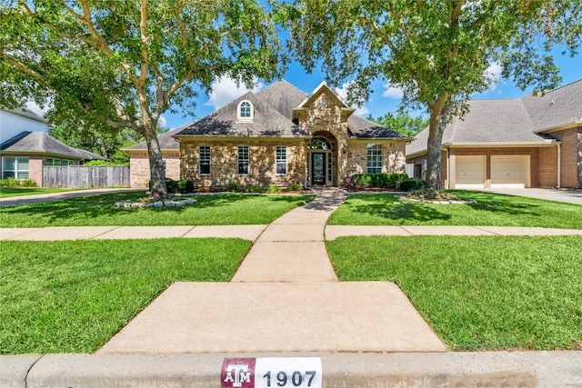 view of front of house featuring a garage and a front lawn