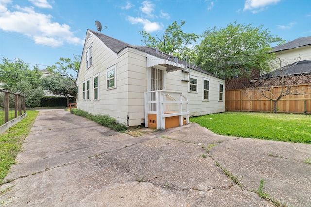 rear view of property featuring a yard