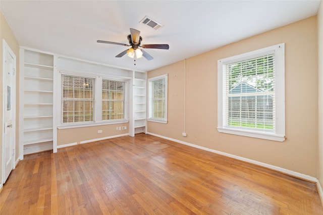 empty room with ceiling fan and wood-type flooring