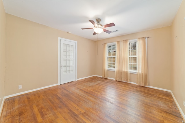 empty room featuring ceiling fan and hardwood / wood-style flooring