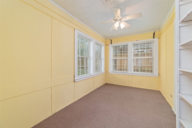 unfurnished sunroom featuring ceiling fan