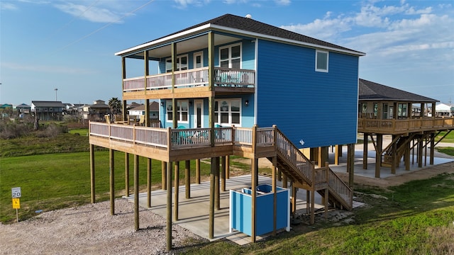 exterior space featuring a wooden deck, a patio area, and a yard